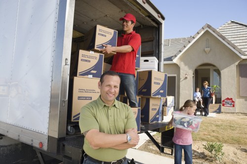 Professional moving team handling boxes and furniture near central London flats